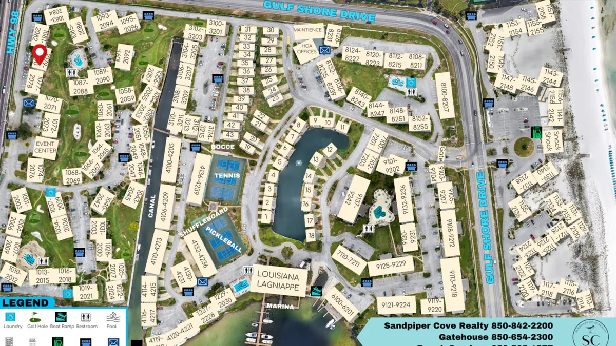 A sweeping aerial view of Sandpiper Cove showcasing the marina with boat docks, multiple sparkling swimming pools, tennis and pickleball courts, landscaped pathways, and direct access to the private beach. The scene is lively, with guests enjoying various outdoor activities such as swimming, sports, and boating.